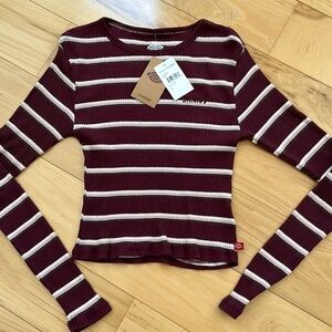Dickies long sleeve snug fit waist top.  NWT size XS.
